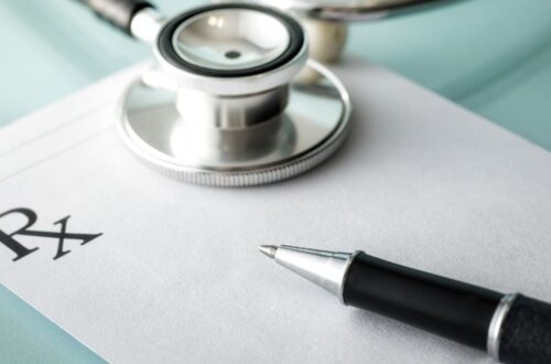 Stethoscope with prescription pad and pen. Patient experience with Tamoxifen