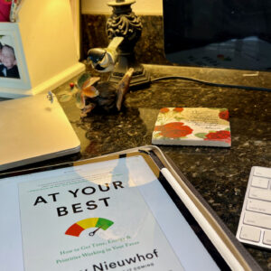 Desk with laptop, At Your Best book, Keyboard and coaster